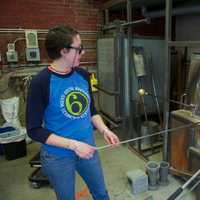 <p>Glass blower Kathleen Andersen spins a new creation at Hudson Beach Glass.</p>