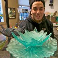 <p>Glass caster Jacob Searles of Beacon - one of over 40 artists whose work can be found at the gallery - with some of his work at Hudson Beach Glass.</p>