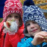 <p>Two boys enjoy their lunch at Sunday&#x27;s Harvest Festival.</p>