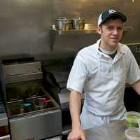 <p>Chef/owner Brian Arnoff at work in his kitchen at Kitchen Sink Food &amp; Drink.</p>