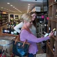 <p>Customers browse wines at the new store.</p>