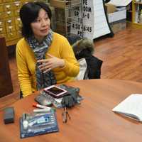 <p>Wei Nitopi, left, explains a point about the Chinese language for Kay Rhee.</p>