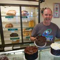 <p>Goodie Shoppe Owner Marc Jayson with some of his cake creations.</p>