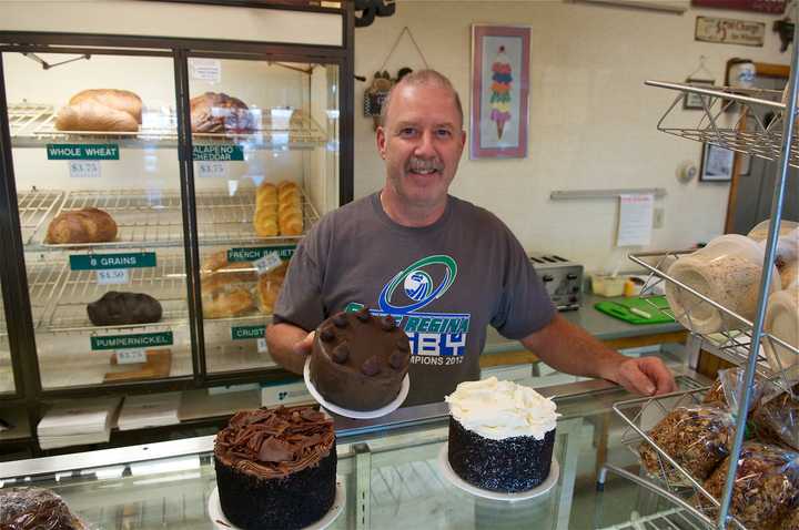 Goodie Shoppe Owner Marc Jayson with some of his cake creations.