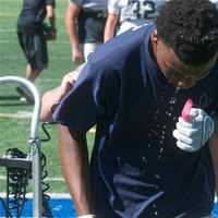 <p>Lourdes players cool off after a practice.</p>