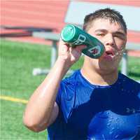 <p>Players cool off at the end of an afternoon practice.</p>