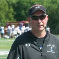 <p>Hen Hud football coach Mike Lynch watches his players at a recent scrimmage.</p>