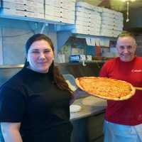 <p>Thin crust, city-style pizza is the name of the game at Carmel Brick Oven Pizza &amp; Cafe in Lake Carmel. Owner Lindita Sutaj is on left.</p>