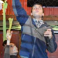 <p>Teacher Assistant Susan Warren of Closter helps Jonathan Yammerino of Closter hang a spider web.</p>