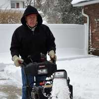 <p>Ed Tellefsen of Allendale snowblows his property.</p>