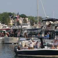 <p>Boats gather near the site of the party to hear the music.</p>