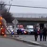 <p>The driver, at right, is helped from the flaming wreck on southbound Route 17 at the Ridgewood Avenue exit in Paramus.</p>