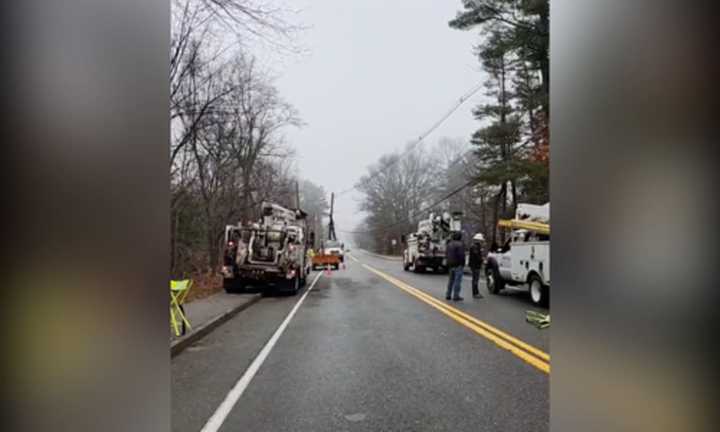 Crews work to restore broken power lines following an overnight car crash near Medway High School.