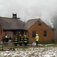 <p>Crews on the scene of a fire at a home in Holland, MA</p>