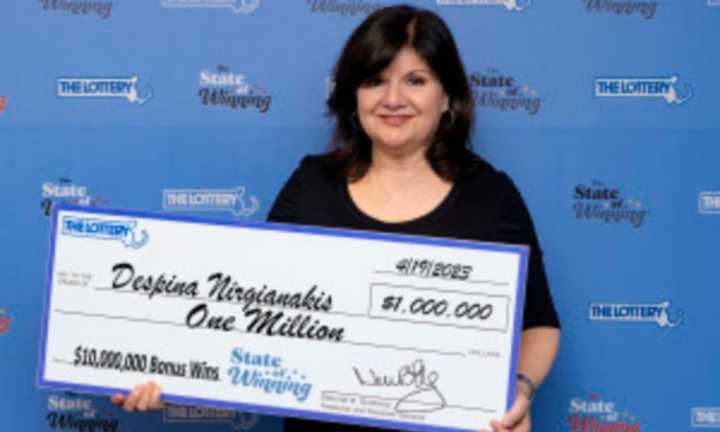 Despina Nirgianakis, of Peabody, holds her $1 million Massachusetts Lottery prize