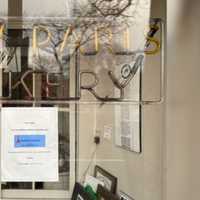 <p>A sign posted in the window of New Paris Bakery says the 104-year-old shop is up for sale</p>