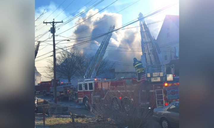 Smoke billowing from a two-alarm fire at an auto body shop in Quincy on Saturday morning, Feb. 4