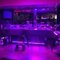 <p>The stage at D&#x27;s Keys is complete with two dueling pianos, a mirror and extra space for drums and guitar for bands to play</p>