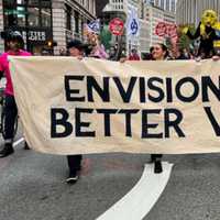 <p>Members of Extinction Rebellion march through the streets of Boston protesting future fossil fuel infrastructure</p>