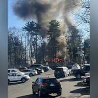 <p>Smoke coming from a house behind Cobbs Corner in Stoughton</p>