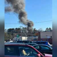 <p>Smoke coming from a house behind Cobbs Corner in Stoughton</p>