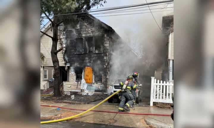 Firefighters on the scene of a multi-alarm fire between two houses in Lynn