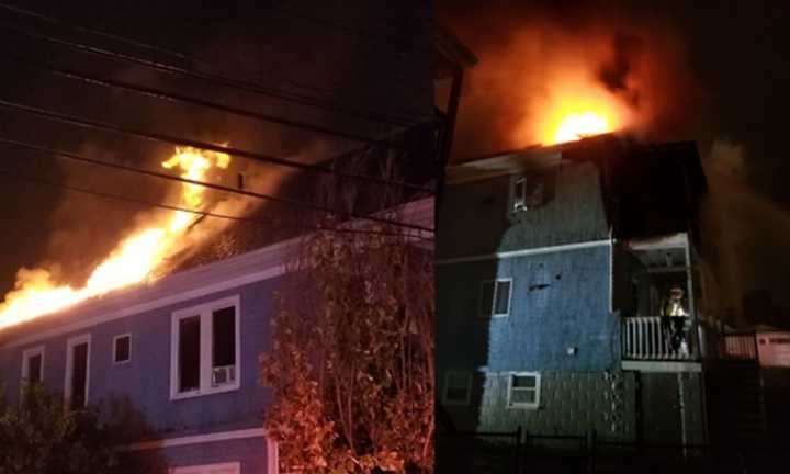 Flames erupt from a 2-alarm fire at a home on Woodlawn Street in Everett