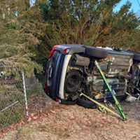 <p>Firefighters arrived to find the vehicle on its side, having smashed into a fence and bushes.</p>