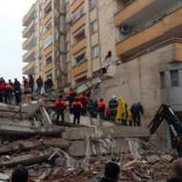 <p>A group of people standing on wreckage from falling buildings in Turkey.</p>