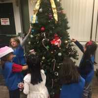 <p>A Saddle Brook Daisy troop spread holiday cheer at the Kessler Rehabilitation Center.</p>