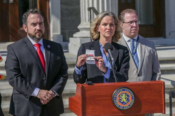 Nassau County Executive Laura Curran shows the counterfeit labels during the kick-off of a new effort to cut down on fake vaping products.