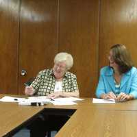 <p>Sister Lorelle Elcock, O.P., Prioress of the Dominican Sisters of Hope, signs the land conservation easement along with Westchester Land Trust president Lori Ensinger.</p>