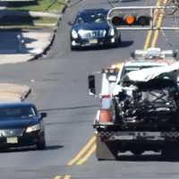 <p>The demolished SUV is trucked away to be impounded for evidence following the pursuit and crash in East Orange.</p>