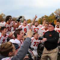 <p>Hasbrouck Heights head coach Nick Delcalzo shares the inaugural NJIC Championship trophy with his team.</p>