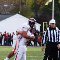 <p>Dylan grabs quarterback Frank Quattrone in a joyous bear hug after winning the first NJIC Championship against Pompton Lakes.</p>