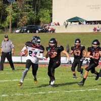 <p>Senior Falcon Sam White Jr. sweeps right around Hasbrouck Heights&#x27; defensive line.</p>