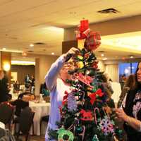 <p>Staff members put the finishing touches on a tree.</p>