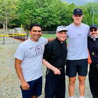 <p>Aaron Judge with Don Bosco staff after a practice session Monday.</p>