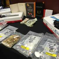 <p>The arsenal of weapons, cash, and drugs seized by Nassau County Police in Farmingdale</p>