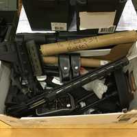 <p>The arsenal of weapons, cash, and drugs seized by Nassau County Police in Farmingdale</p>