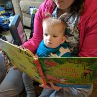 <p>Emmeline of Norwood, 21 months, reads with her nurse at CHOP.</p>