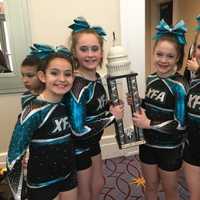 <p>Members of Explosion, a cheerleading team from Extreme Force Allstar Cheer, a Mahopac cheerleading/tumbling program and gym, show off the team&#x27;s trophy in Washington, D.C.</p>