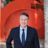 <p>Michael Gitlitz in front of Mark di Suvero’s sculpture called Yoga in the sculpture garden at Katonah Museum of Art.</p>