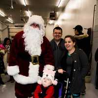 <p>Julie, Chris and Emmeline Krcmaric with Santa.</p>