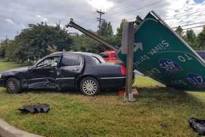 Bethesda Vehicle Collision Knocks Over Massive Road Sign, Entraps At Least One