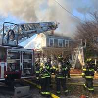 <p>Crews working to contain a fire at 11A Union Street in Natick</p>