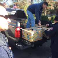 <p>Firefighters prepare Thanksgiving baskets ready for delivery.</p>