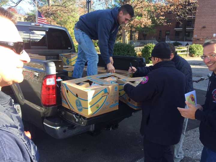 Firefighters prepare Thanksgiving baskets ready for delivery.