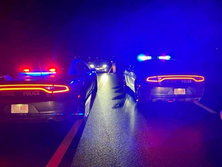 Police cars face off with the silver sedan involved in the incident.