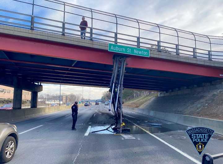 The bridge was hit by a truck with a pneumatic lift for a dumpster that was in the raised position.